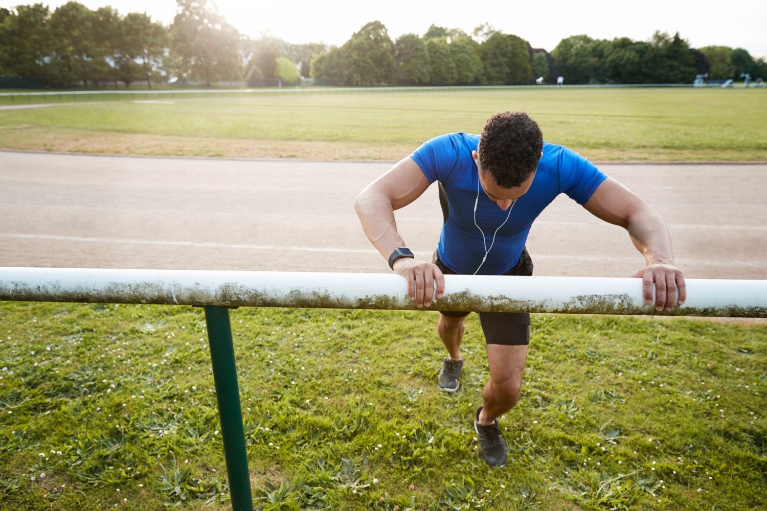 Young Athlete Getting Ready for Race By Stretching Aching Heels and Ankles