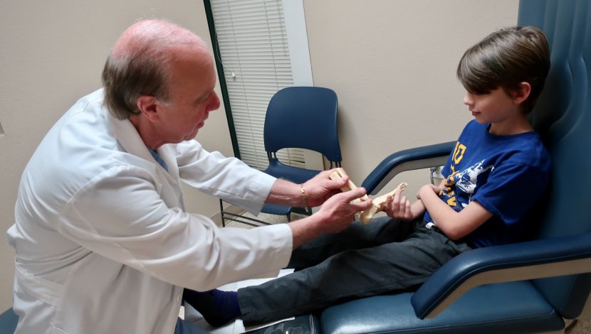 Young Patient Describing Foot Pain and Discomfort with Foot Model