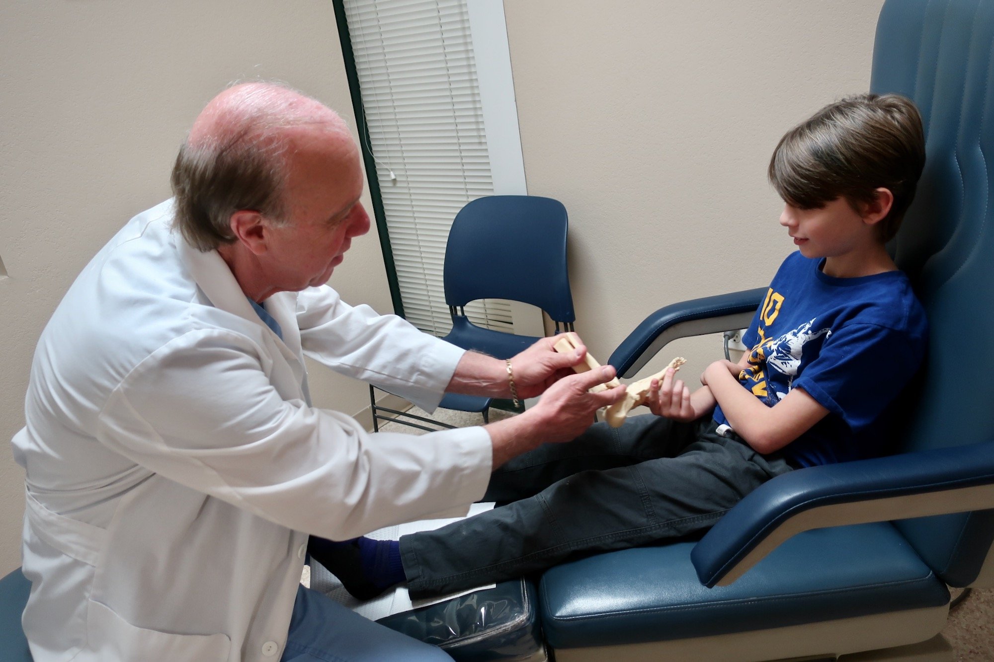 Young Patient Describing Foot Pain and Discomfort with Foot Model