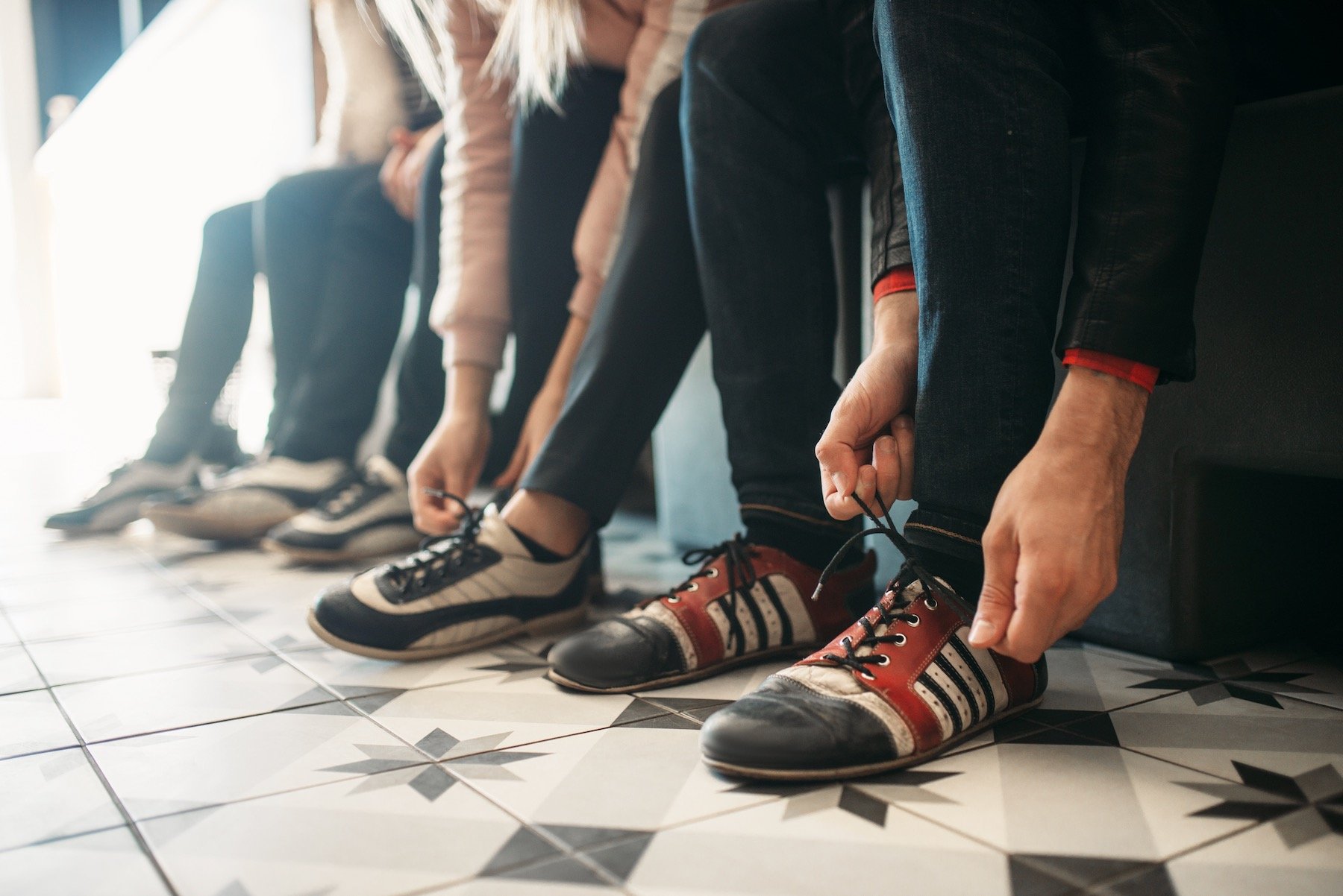Bowling players ties shoelaces on house shoes Bowlers sharing shoes have an increased risk of plantar warts