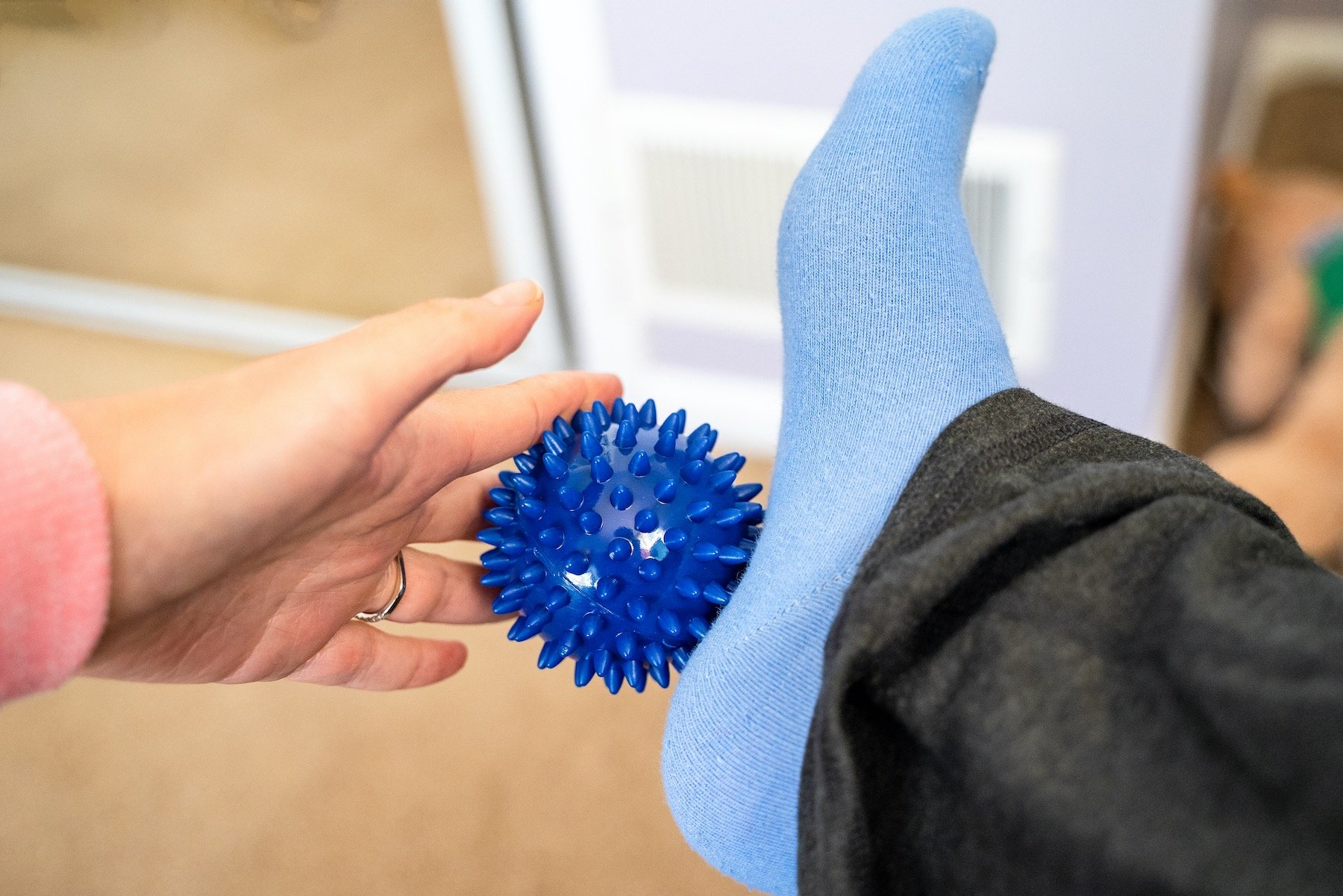 woman-massaging-feet-to-alleviate-bone-spur-pain-and-treatment_afd Woman Stretching Ball Under Foot to Get Rid of Bone Spurs Without Surgery
