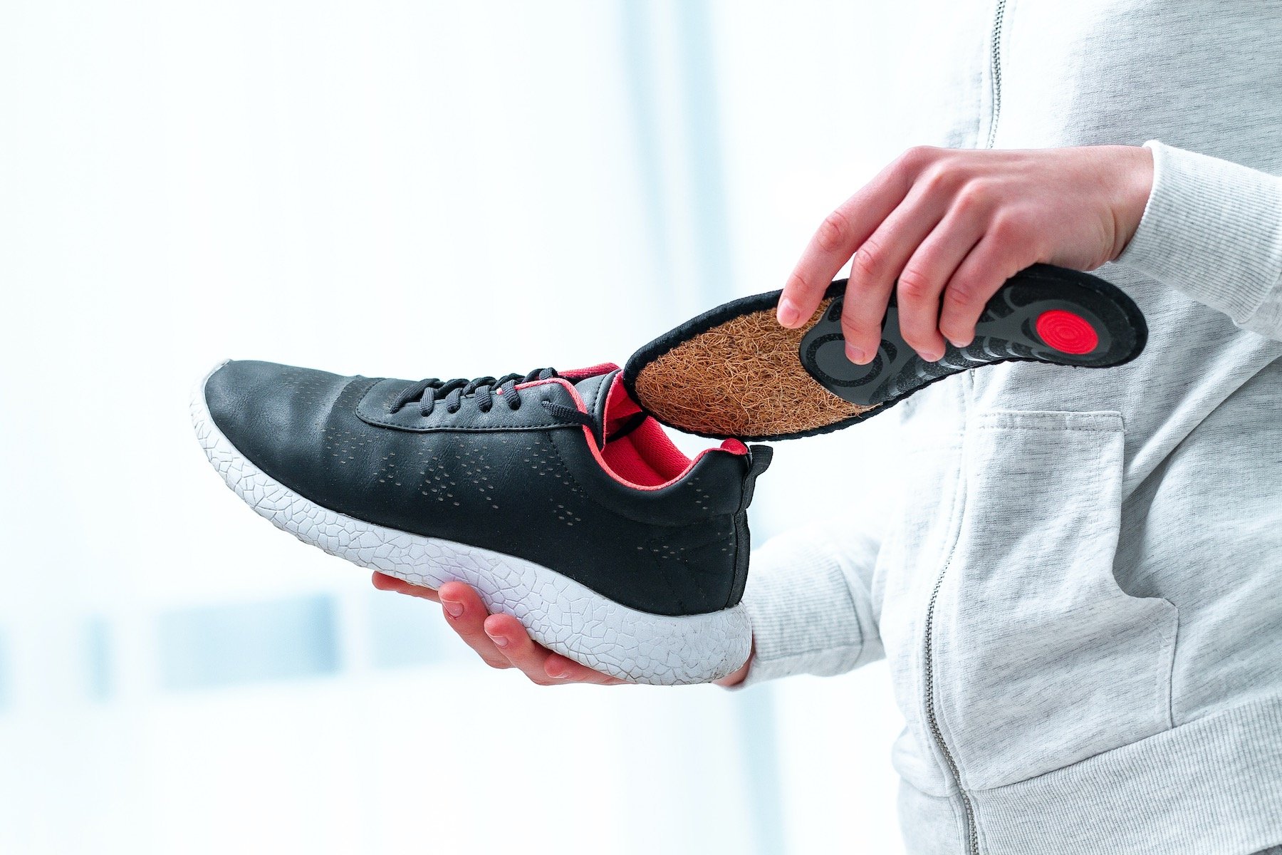 Woman Inserting Orthotic, The Best Product for Foot Pain