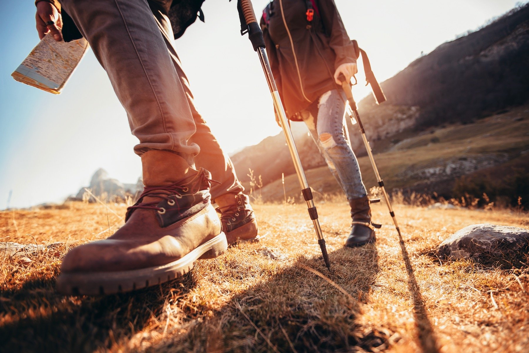 TWO PEOPLE'S SHOES AS THEY ARE HIKING